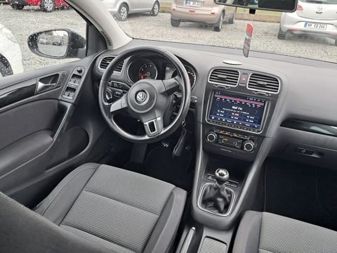 Interior view of a Volkswagen car dashboard and steering wheel with gray upholstery and touchscreen display